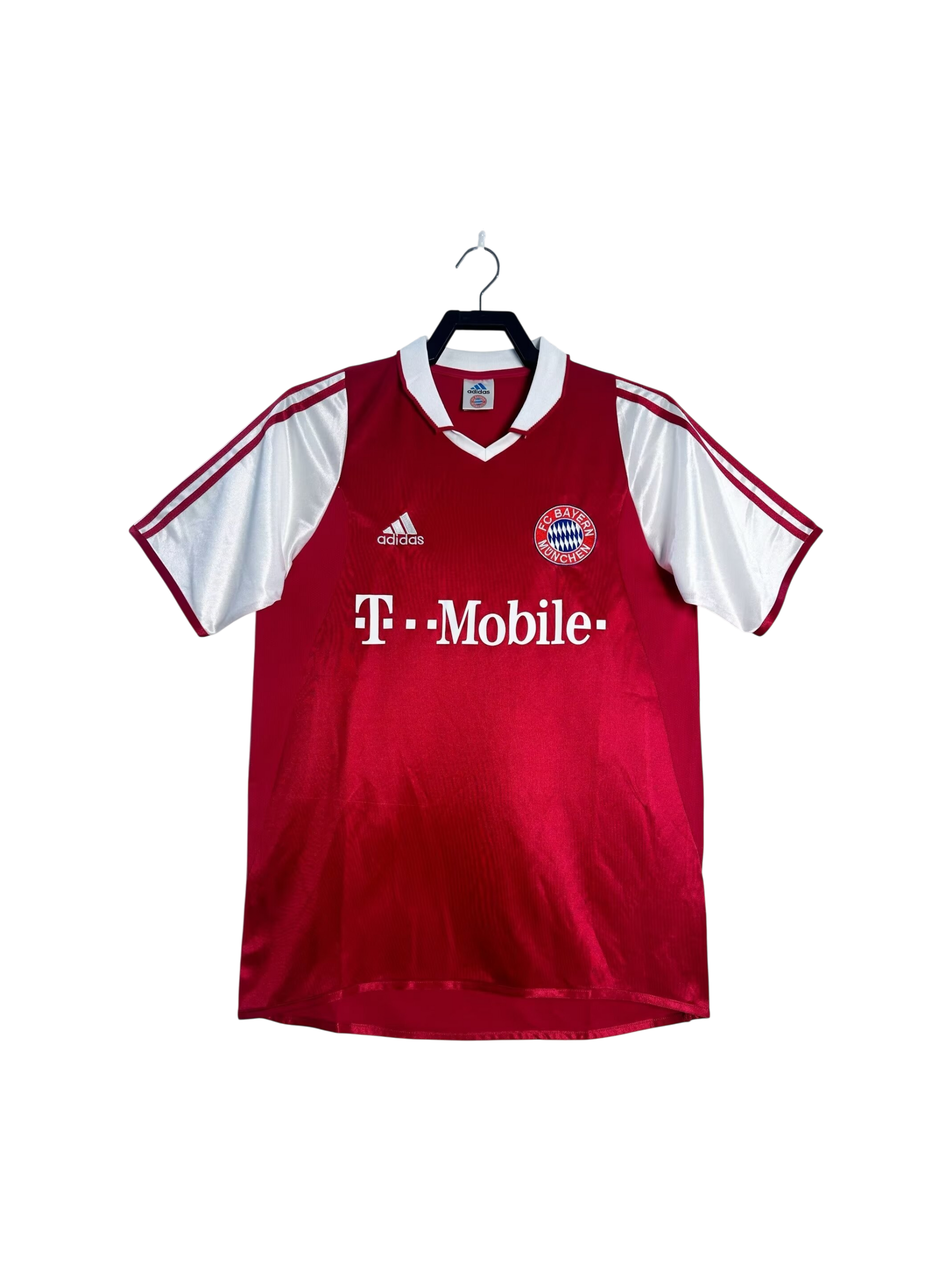 Red sports jersey with white sleeves on a hanger against a white background