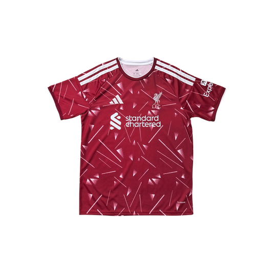 A red short-sleeve soccer jersey with white geometric line patterns, featuring the Liverpool club crest, the 'standard chartered' sponsor logo, and white stripes on the shoulders, displayed against a solid white background.