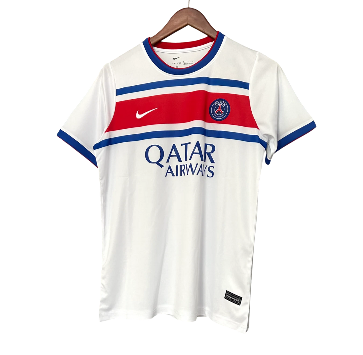 A white Paris Saint-Germain soccer jersey with blue and red stripes, featuring the Nike swoosh, the club crest, and 'QATAR AIRWAYS' sponsor text, hanging on a wooden hanger against a white background.