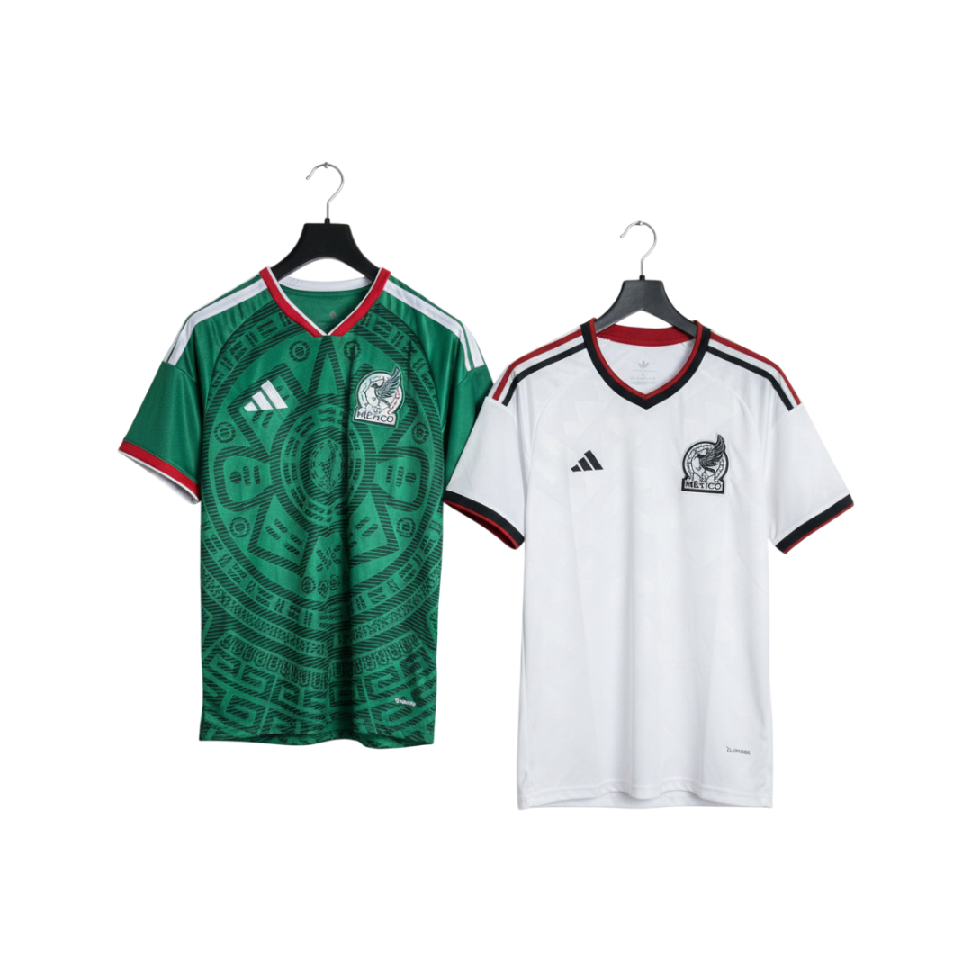 Green and white sports jerseys on hangers with Adidas logo.