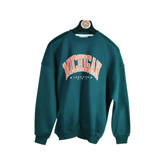 Green sweatshirt with 'Michigan' printed on it, hanging on a white background
